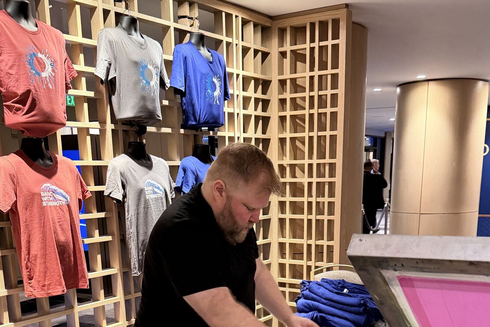 Freshly printed shirts handed back to guests at the event