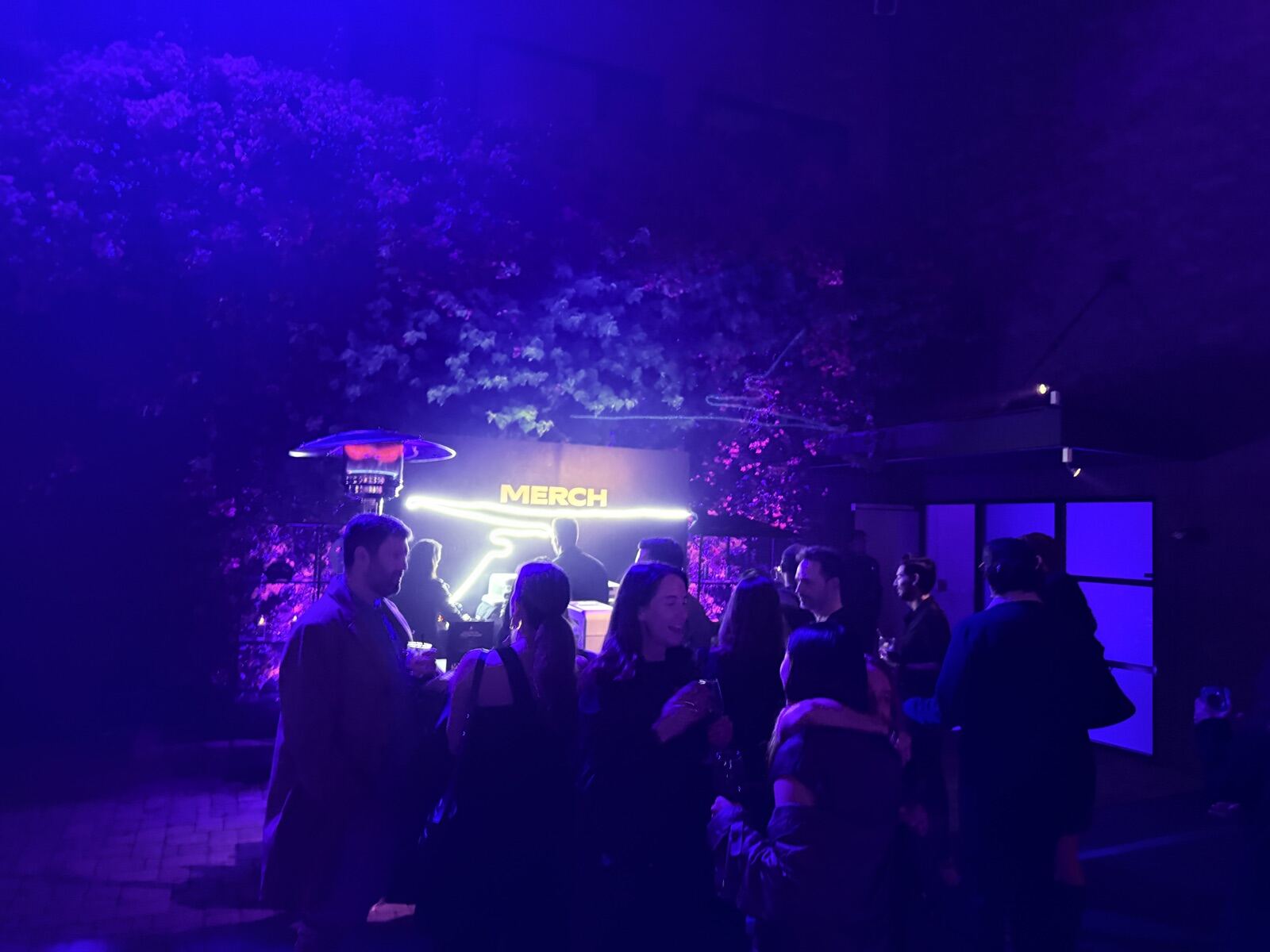 Guests lined up at a live t-shirt printing booth choosing designs
